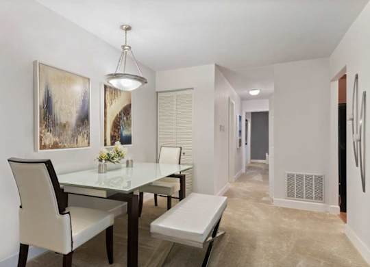 A dining room with a glass table and chairs.