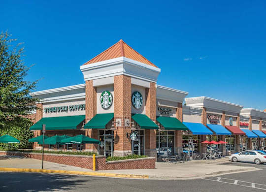 A Starbucks coffee shop is located in a strip mall.