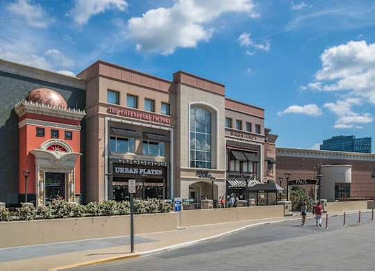 A building with a pig on the front has a sign that says Urban Plates.