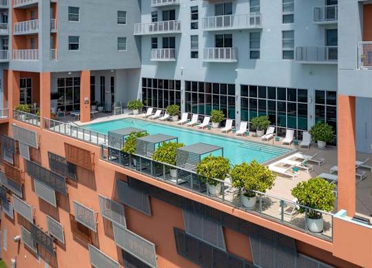 a view of the pool from the top of an apartment building