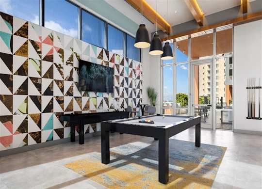 a game room with a pool table and a television