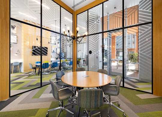 a conference room with a wooden table and chairs