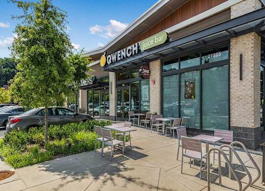 a patio outside of a restaurant with tables and chairs