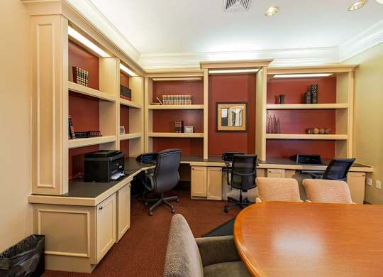 a conference room with two desks and a table and chairs
