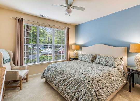 a bedroom with a bed and a ceiling fan