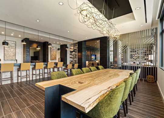 a dining room with a wooden table and chairs