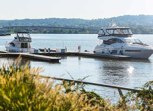a group of boats docked at a dock on the water