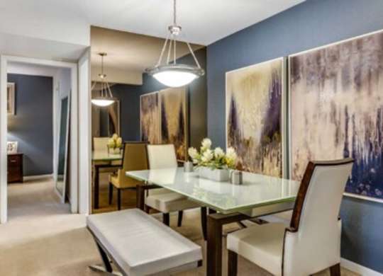 a blurry photo of a dining room with a table and chairs