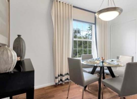 a dining room with a table and chairs and a window