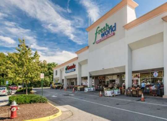 the facade of a grocery store with a parking lot