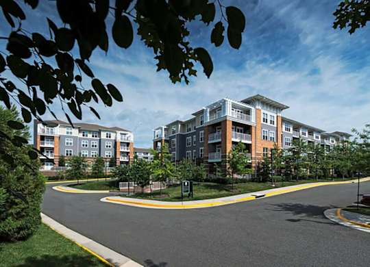 a street view of an apartment building with a road in front of it