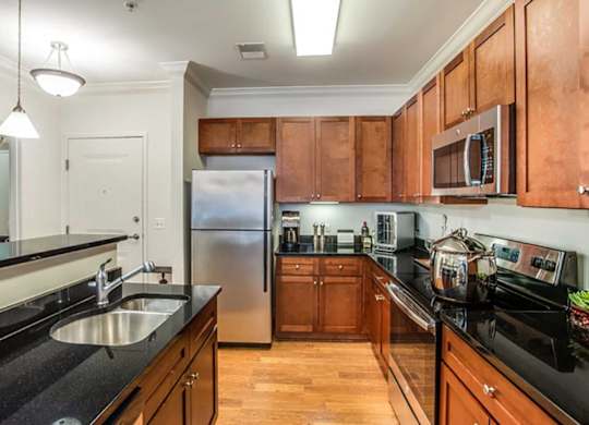 a kitchen with wooden cabinets and a stainless steel refrigerator