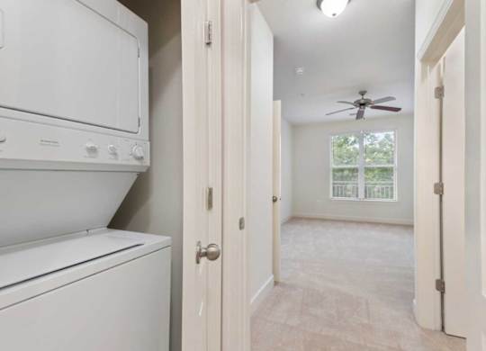 an empty laundry room with a washer and dryer