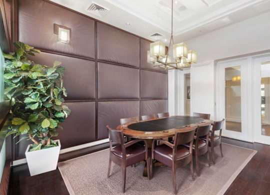 a dining room with a wooden table and chairs