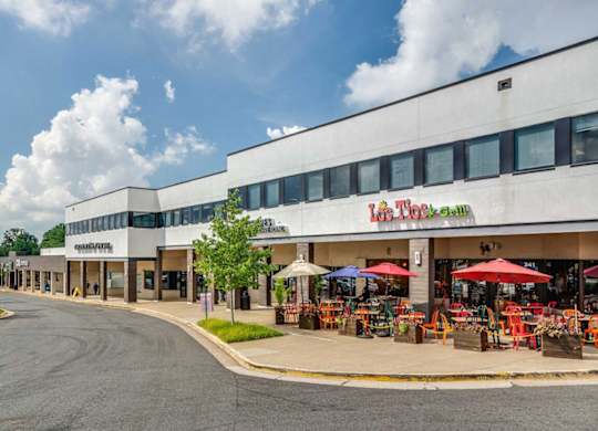 A street view of a shopping area with a store named