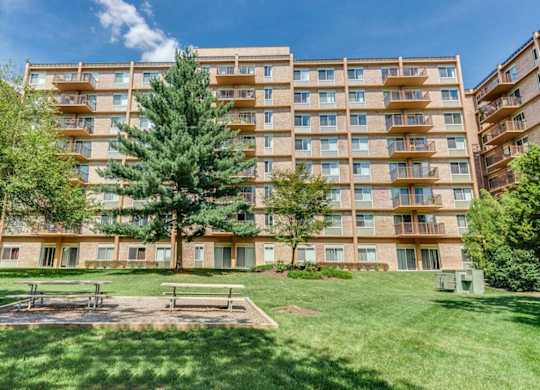 A large apartment building with a playground in front.