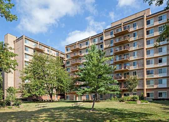 A large grassy area in front of apartment buildings.