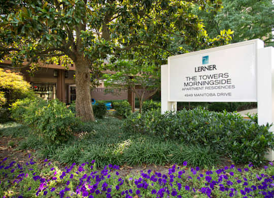 A white sign with the name Lerner and The Towers Morningside Apartment Residences on it.