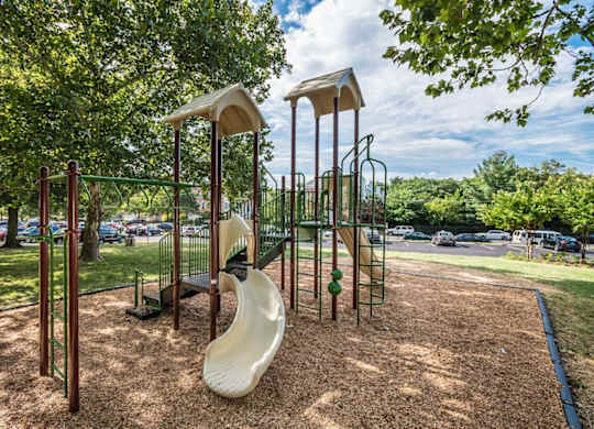 A playground with a slide and swings.