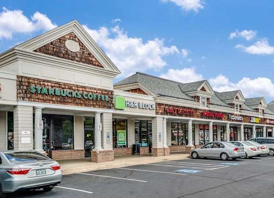 A Starbucks Coffee sign is on the front of a building.