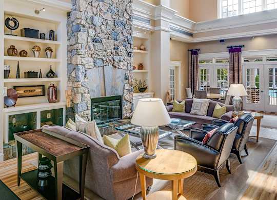 A living room with a stone pillar and a fireplace.