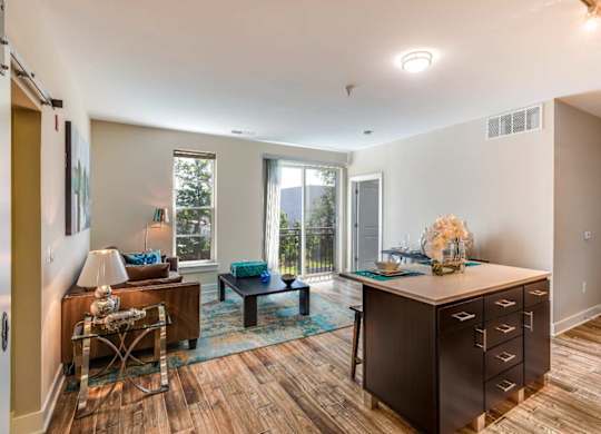 A room with a brown island and a blue chair.