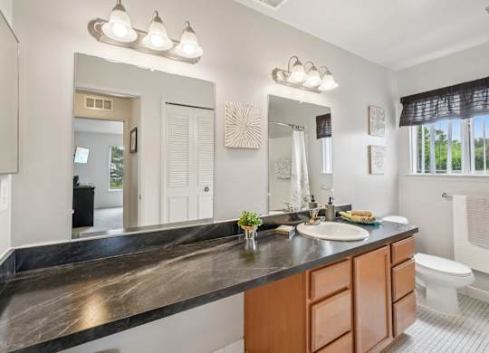 Spacious bathroom with ample storage at Drawbridge Apartments in Harrison Township, MI.