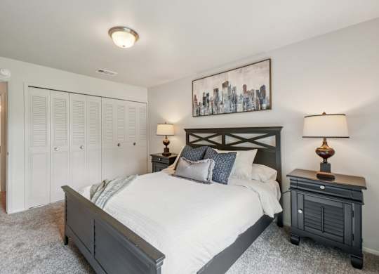 Cozy bedroom with ample storage space at Drawbridge Apartments in Harrison Township, MI.