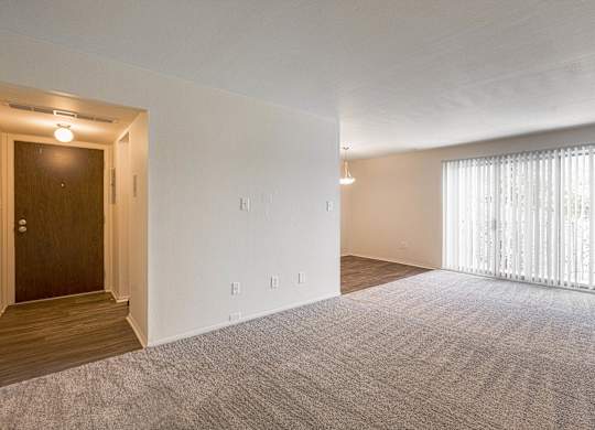 Open and airy entry way and living room at Knottingham Apartments in Clinton Township, MI