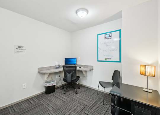 Modern business center with computer at Drawbridge Apartments in Harrison Township, MI.