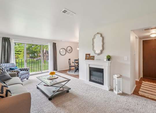 Elevated living room and private patio or balcony at Drawbridge Apartments in Harrison Township, MI.