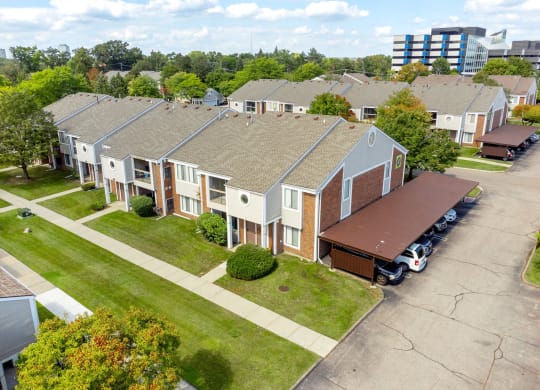 an aerial view of a row of houses with a parking lot