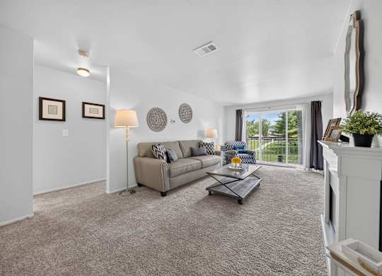 Elevated living room and private balcony at Drawbridge Apartments in Harrison Township, MI.