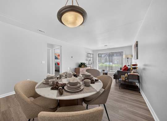 Open concept Living-Dining Area with natural lighting at Lakeside Village Apartments Clinton Township, MI