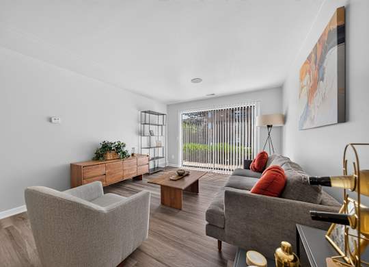 Spacious Living Room with Sliding Glass Door at Lakeside Village Apartments in Clinton Township, MI