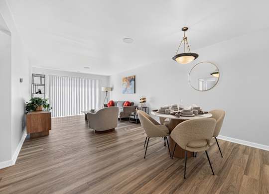 Open concept Living-Dining Area with natural lighting at Lakeside Village Apartments Clinton Township, MI