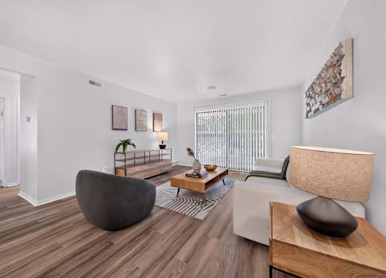 Spacious Living Room with Sliding Glass Door at Lakeside Village Apartments Clinton Township MI