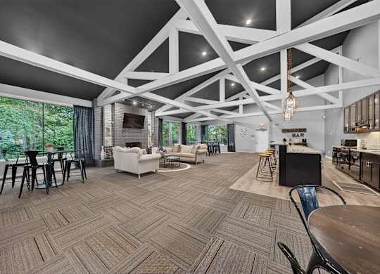 A spacious room with a patterned floor and a bar area.