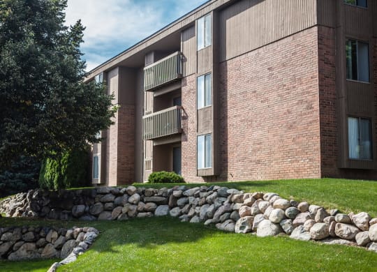 Exterior building with trees in courtyard at Dover Hills Apartments in Kalamazoo, MI