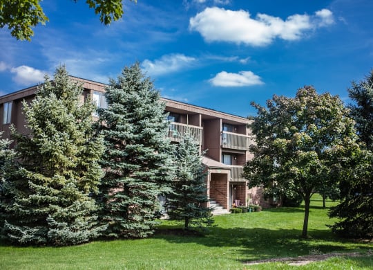 Exterior building with trees in courtyard at Dover Hills Apartments in Kalamazoo, MI