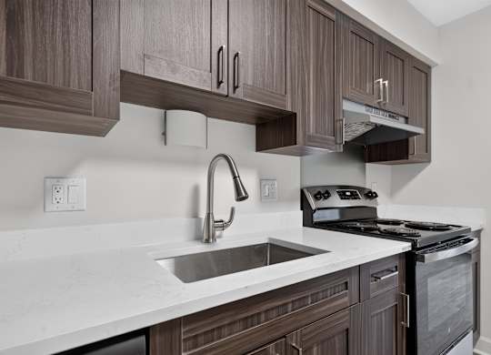 Modern kitchen with stainless steel appliances at Franklin River Apartments in Southfield, MI.