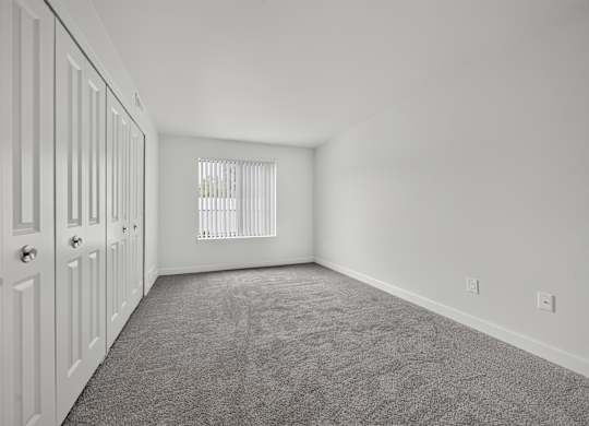 Bedroom with ample storage at Franklin River Apartments in Southfield, MI.