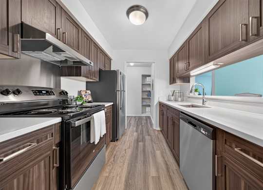 Modern kitchen with stainless steel appliances at Franklin River Apartments in Southfield, MI.