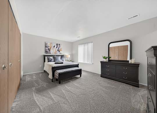 Spacious bedroom with ample storage at Franklin River Apartments in Southfield, MI.