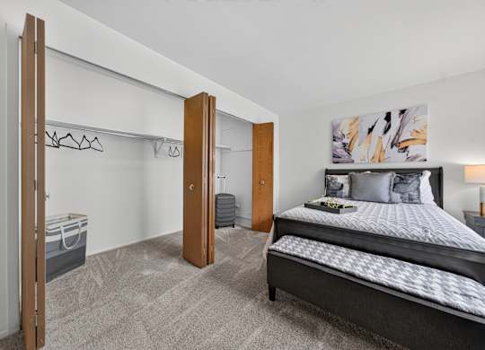 Bedroom with ample storage space at Franklin River Apartments in Southfield, MI.