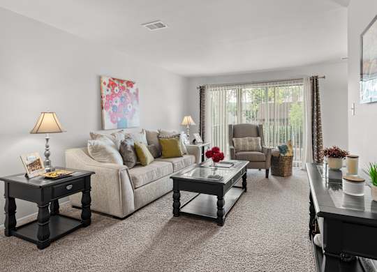 Open and airy living room with natural lighting at Knottingham Apartments in Clinton Township, MI.
