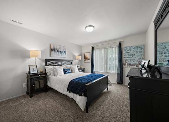 Spacious bedroom with ample storage space at Knottingham Apartments in Clinton Township, MI.
