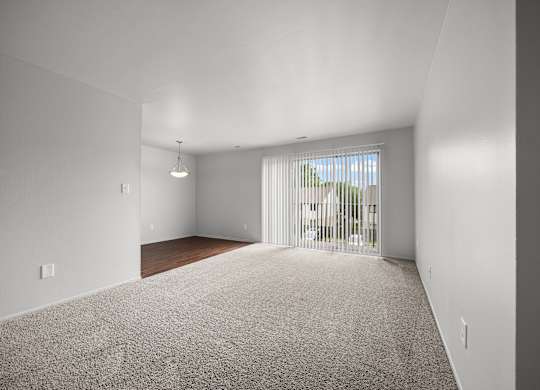 Open and airy living room with natural lighting at Knottingham Apartments in Clinton Township, MI.