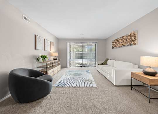 Spacious Living Room with Sliding Glass Door at Lakeside Village Apartments Clinton Township MI