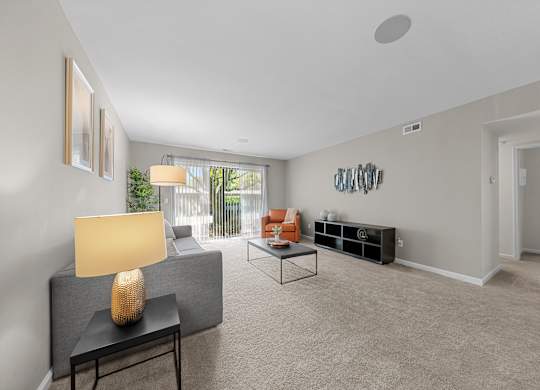 Spacious Living Room with Sliding Glass Door at Lakeside Village Apartments Clinton Township MI